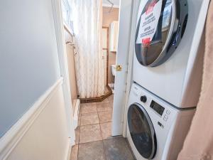 a washer and dryer in a room with a door at Downtown Whitehorse Apartment in Old Town in Whitehorse