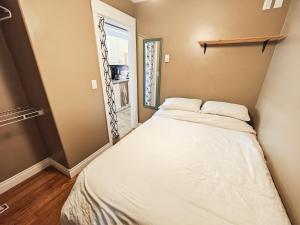 a large bed in a room with a window at Downtown Whitehorse Apartment in Old Town in Whitehorse