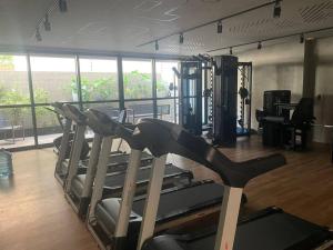 a gym with a bunch of tread machines in a room at Apartamento em Ponta Verde in Maceió