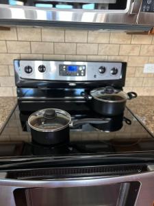 a stove with two pots on top of it at The Bentler #2 in Houston