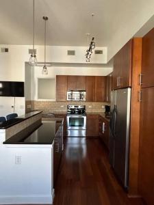 a kitchen with wooden cabinets and stainless steel appliances at The Bentler #2 in Houston