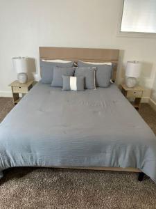 a bedroom with a large bed with two end tables at The Bentler #2 in Houston