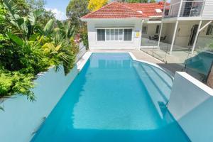an image of a swimming pool in front of a house at Keiraville Poolside Escape - University Proximity in Keiraville