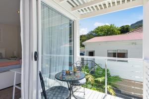a balcony with a table and a view of a bedroom at Keiraville Poolside Escape - University Proximity in Keiraville