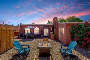 a backyard with two chairs and a fire pit at Historic Guesthouse 2 Blocks from the U of A in Tucson