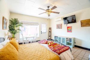 a bedroom with a bed and a ceiling fan at Historic Guesthouse 2 Blocks from the U of A in Tucson