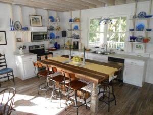 a kitchen with a table and chairs in a room at Beach Haven, 600 feet from the Beach !! in Daufuskie Landing