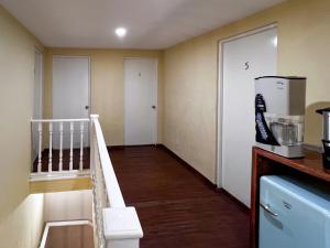 a room with a kitchen with a microwave and a refrigerator at Discover Condesa Ideal Location in Mexico City +53 photos