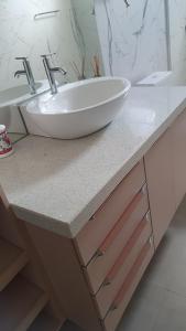 a bathroom counter with a white bowl sink on it at Residencial Mirandinha in Boa Vista