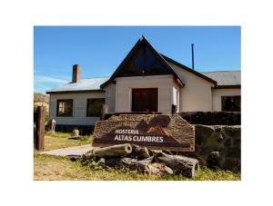 a sign in front of a house at Hostería Altas Cumbres in El Chalten +21 photos