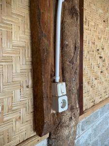 a pipe sticking out of a wooden door at rk.homestay in Rantepao
