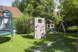 um parque infantil com uma estrutura de escalada e um escorrega em Wellness Ferienwohnung Schweinsteiger mit Hallenbad und Sauna em Oberaudorf