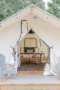 a white tent with a bed in it at Luxury Glamping Tents @ Lake Guntersville State Park in Guntersville