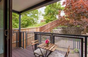 a patio with a table and chairs on a balcony at Manor House Studios By Morethanstays in London