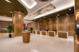 a lobby with a waiting area with people in the background at St Giles Southkey in Johor Bahru
