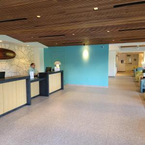 a man sitting at a counter in a hospital lobby at Waikiki Shore Beachfront in Honolulu