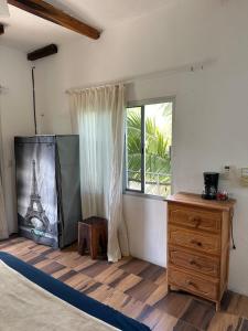 a bedroom with a bed and a window with the eiffel tower at Haciendita Xul-Ha in Xul-Ha