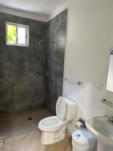 a bathroom with a toilet and a sink at Haciendita Xul-Ha in Xul-Ha
