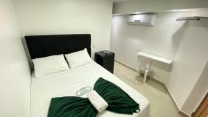 מיטה או מיטות בחדר ב-HOTEL CENTRAL MARGARITA