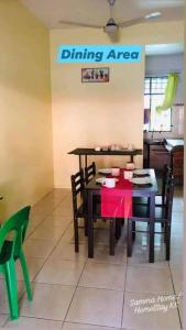 a dining area with a red table and chairs at Samma HomeStay Double Storey Terrace House in Kota Kinabalu