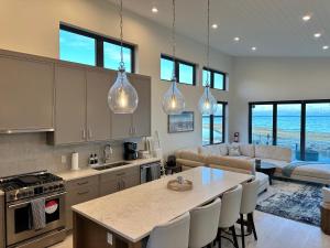 a kitchen and living room with a table and chairs at Saratoga Serenity at THE BEACH HOUSE in Campbell River