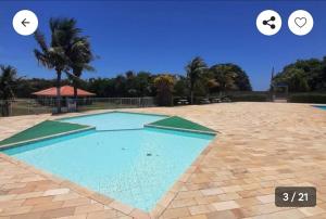 a large blue swimming pool with two circles around it at Casa Nova Araruama in Araruama