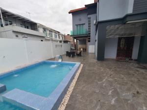 uma piscina em frente a um edifício em VILLA SARA PRIVATE POOL ALOR SETAR em Langgar