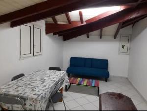Habitación con mesa y silla azul en F2 pointe-à-pitre proche terminal de croisière, en Pointe-à-Pitre