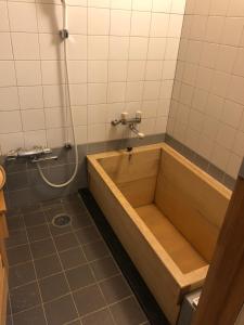 a bath tub in a bathroom with a shower at Hananoyado Fukuya in Hakone