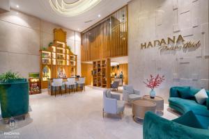a lobby of a hotel with a restaurant at Hadana Boutique Hotel Danang in Da Nang