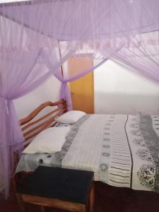 a bedroom with a bed with a canopy at River Edge Udawalawe in Udawalawe