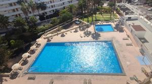an overhead view of a swimming pool at a hotel at Blanco&Azul - Ocean View Balcony, Pool and Perfect Location in Playa de las Americas