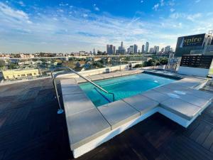 a swimming pool on top of a building with a city skyline at Downtown Los Angeles Skyline balcony view Modern Penthouse in Los Angeles