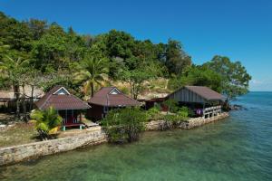 an island withtropical houses on the water at Sok Sabay in Koh Rong Island