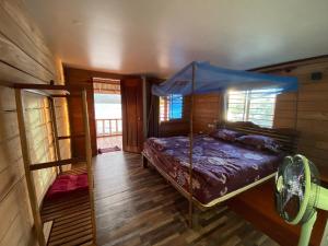 a bedroom with a bed with a canopy at Sok Sabay in Koh Rong Island