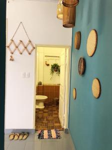 a room with a bathroom with a toilet and a doorway at Luna Old Quarter Homestay room #3 in Hanoi