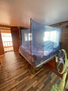 a bedroom with a bed with a mosquito net at Sok Sabay in Koh Rong Island