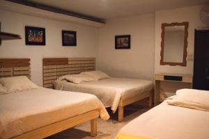 Una cama o camas en una habitación de Hotel Raíces Casona Real