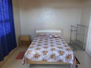 ein Schlafzimmer mit einem Bett mit einer Bettdecke darauf in der Unterkunft Bois Gournable in Rodrigues Island