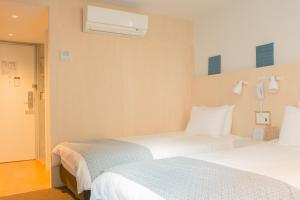 Postel nebo postele na pokoji v ubytování DOMO Hotel