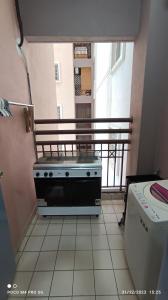 a kitchen with a stove on a balcony at Homestay Saujana Aster @ Putrajaya in Putrajaya