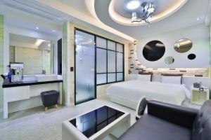 a bedroom with a large bed and a bathroom at G&G Hotel in Ulsan