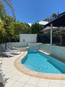 a small swimming pool in a yard with a patio at Byron Getaway @ Eco Beach in Byron Bay