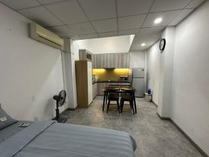 a room with a bed and a kitchen with a table at 123 House with cinema room in District 1 in Ho Chi Minh City