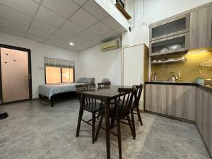 a kitchen and dining room with a table and chairs at 123 House with cinema room in District 1 in Ho Chi Minh City