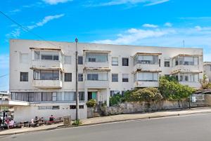 a white building on the side of a street at Ocean View 1 bedroom Private Apartment next to Maroubra Beach in Sydney