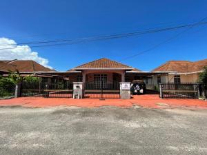 a house with a black fence in front of it at HOMESTAY IZHAN BANDAR KUALA TERENGGANU in Kuala Terengganu