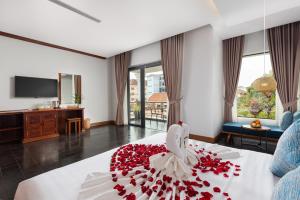 a hotel room with a bed with flowers on it at Khmer House Boutique in Siem Reap