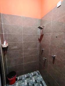 a bathroom with a shower with a toilet and a sink at Roomstay Kak Ton in Kuala Terengganu