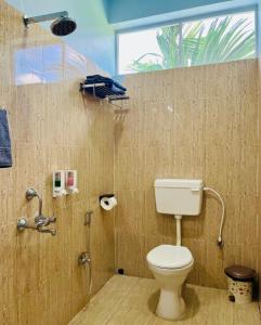 a bathroom with a toilet and a shower at Bhūma in Havelock Island